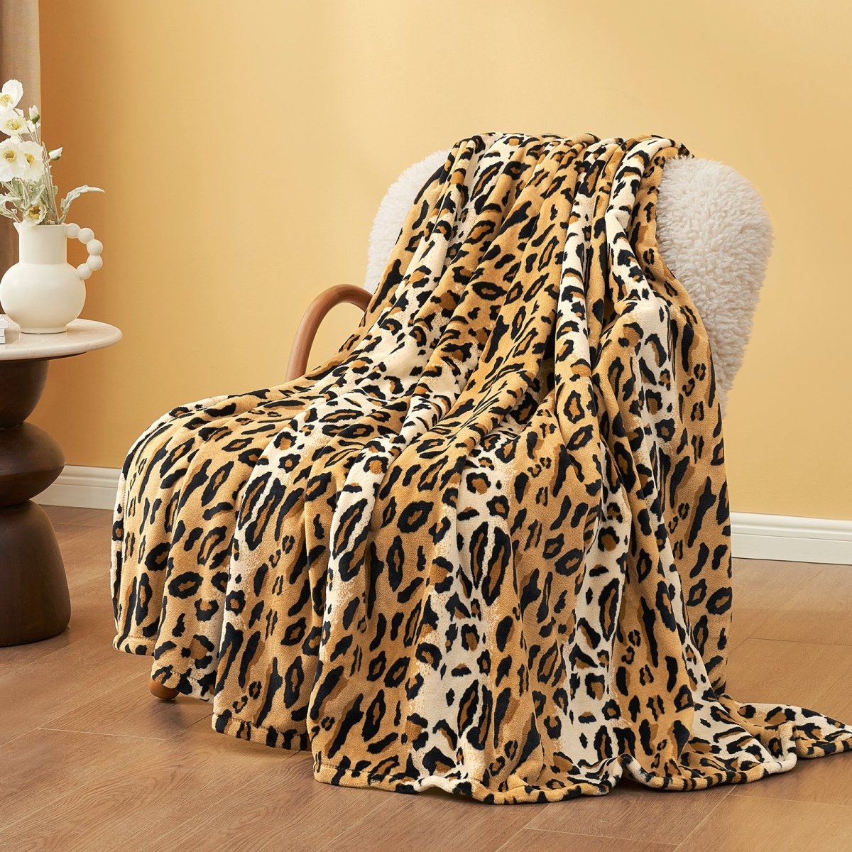 Cozy Bliss Leopard Print MilkyPlush Throw Blanket draped over chair #color_Brown Leopard