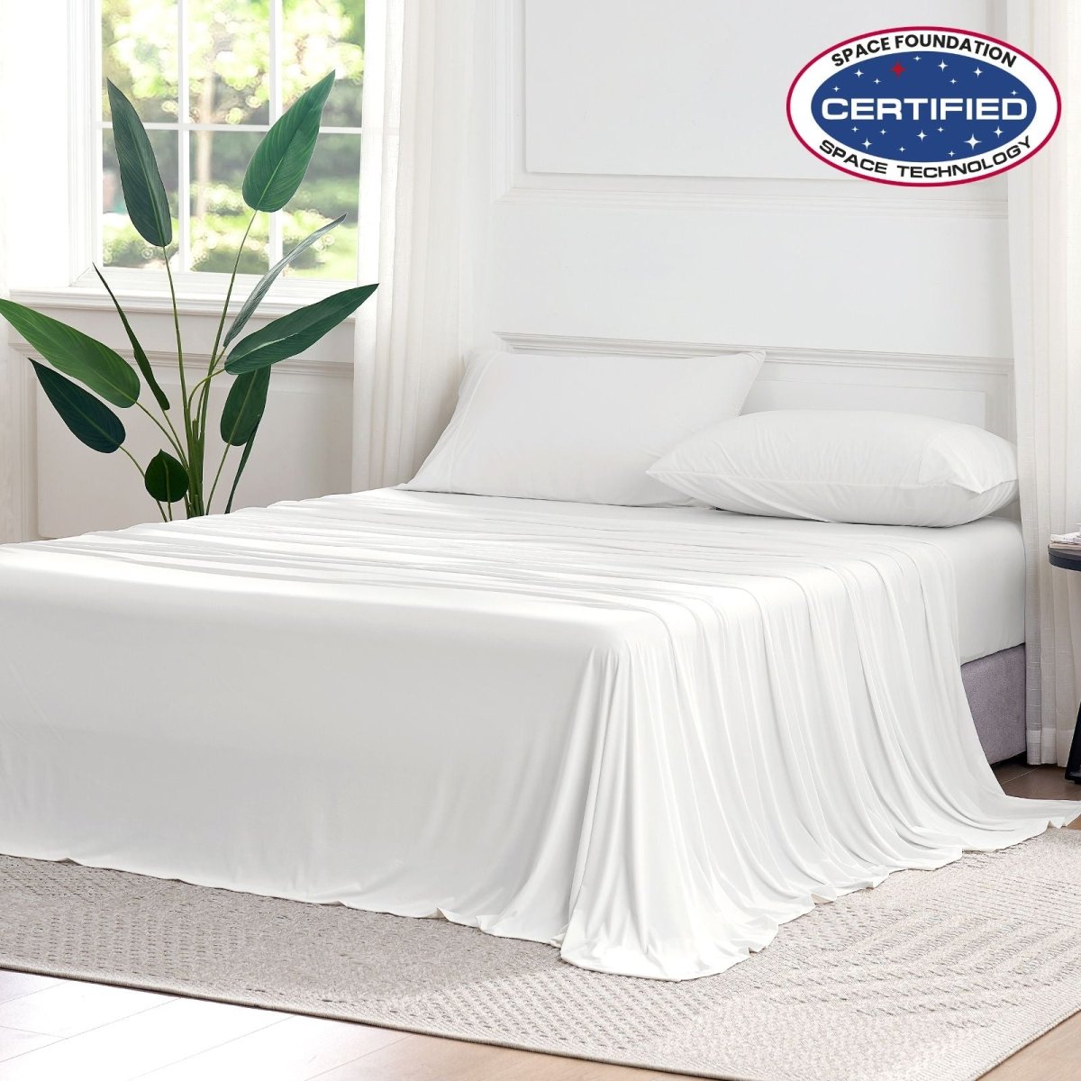 Cozy Bliss Outlast® Performance Cooling Sheet Set draped across a bed in a bright bedroom, showcasing the complete bedding appearance. #color_Off White