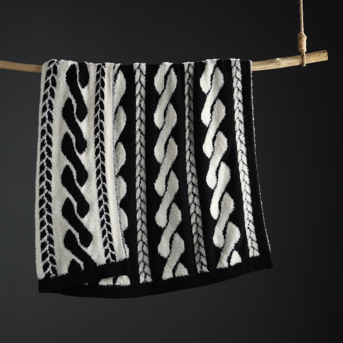 Faux Mink Cable Knit Throw Blanket in Black hanging display front view, showcasing cable knit pattern and plush faux mink texture. #color_Black