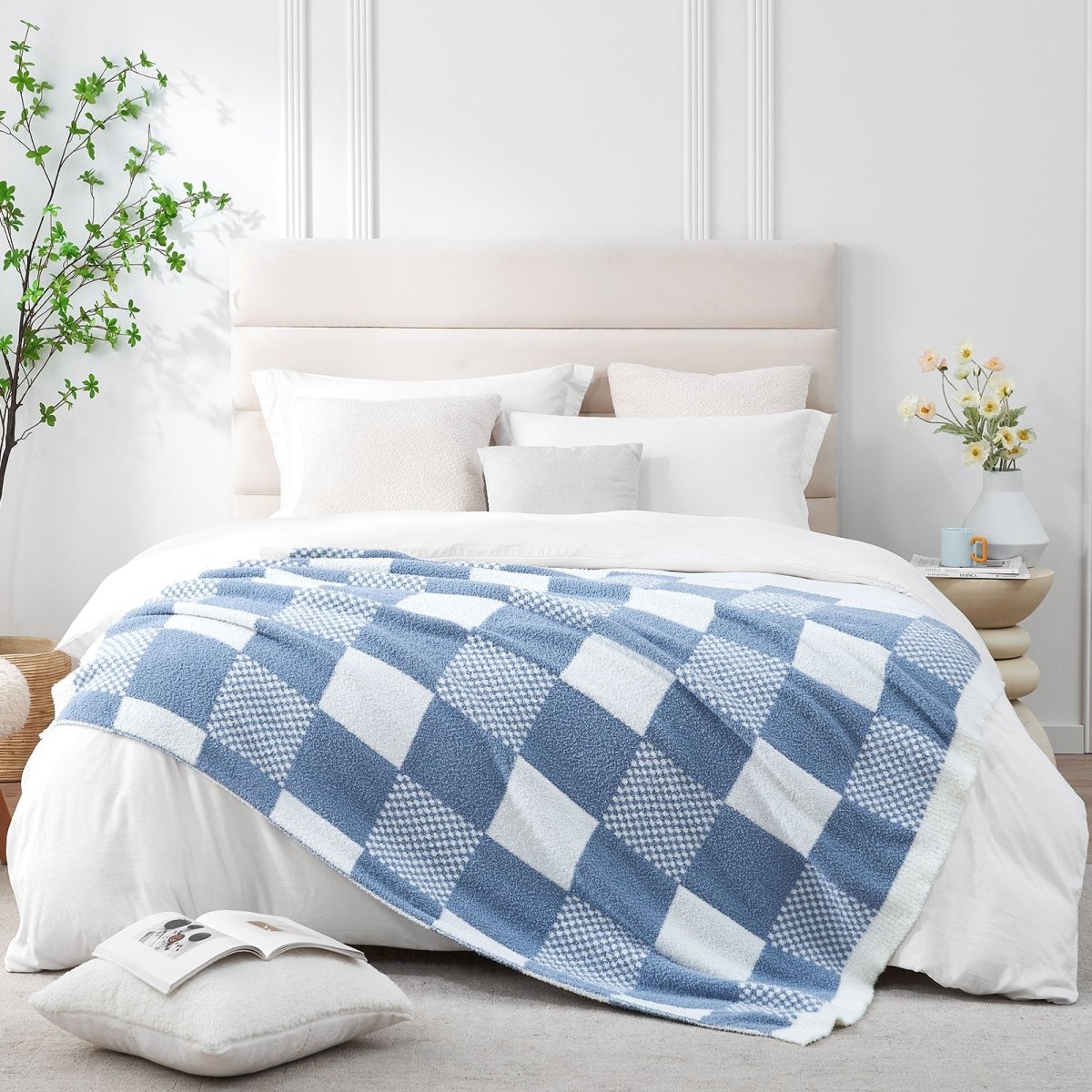 Checkered Feather Yarn Throw Blanket in Dark Blue styled on a bed, adding a light and cozy layered look. #color_Dark Blue