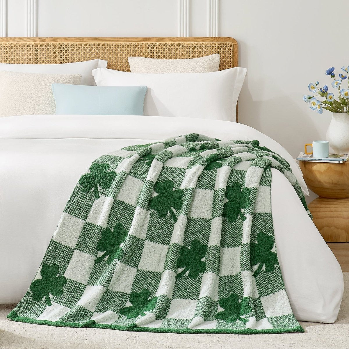 Green and white checkered blanket with shamrock pattern on a bed #color_Xmas Green