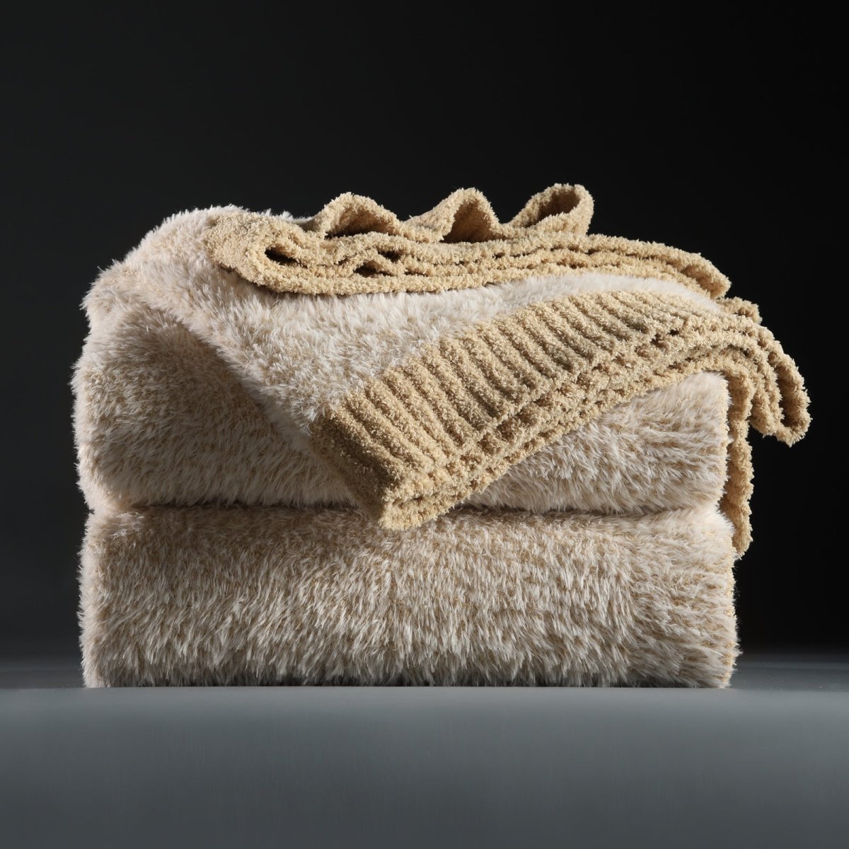 Faux Mink Feather Knit Throw Blanket in Beige neatly folded stack, showcasing soft feather yarn and premium texture. #color_Beige