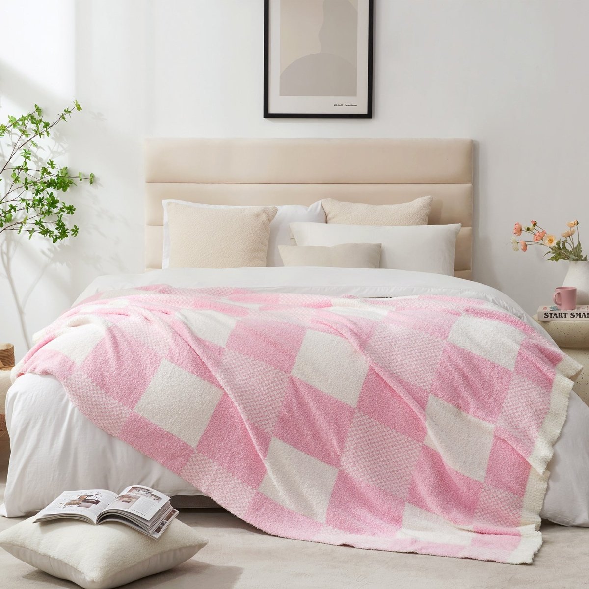 Checkered Feather Yarn Throw Blanket in Pink styled on a bed, adding a clean and cozy layered look to bedroom decor. #color_Pink White