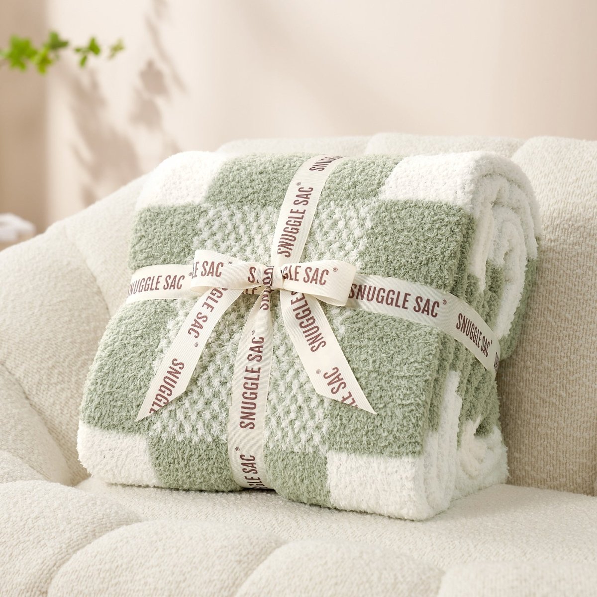 Checkered Feather Yarn Throw Blanket in Sage Green & White neatly folded as gift packaging, perfect for holidays and special occasions. #color_Sage Green & White