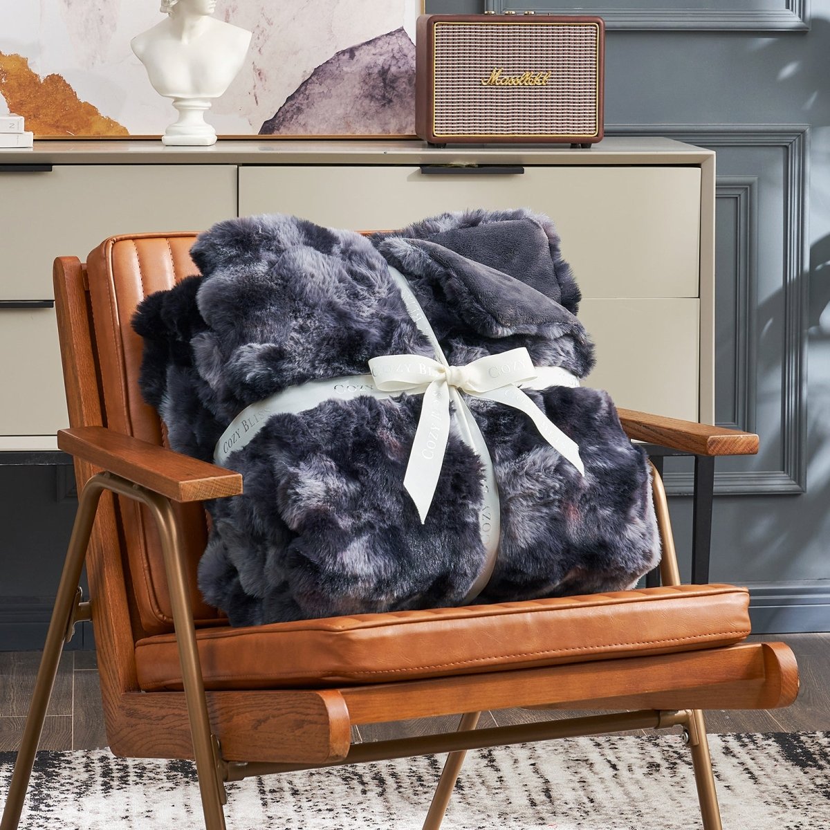 Cozy Bliss tie-dye faux fur throw blanket on an armchair #color_Tie-dye Black