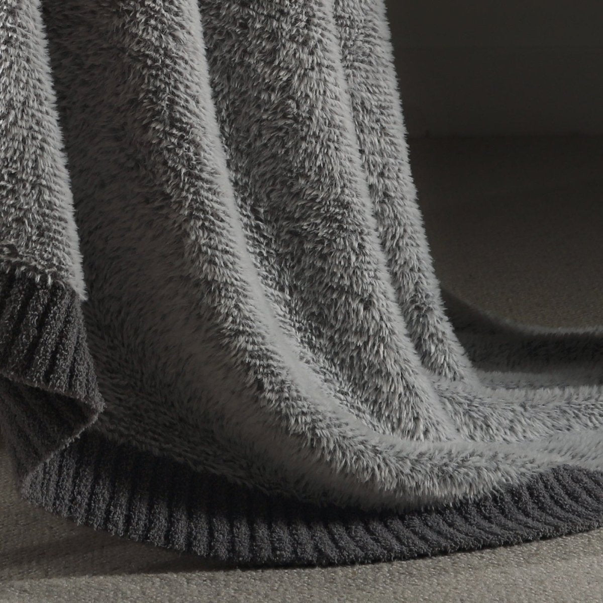 Close-up of faux mink texture on Faux Mink Feather Knit Throw Blanket in Grey highlighting soft plush fibers and cozy feel. #color_Grey