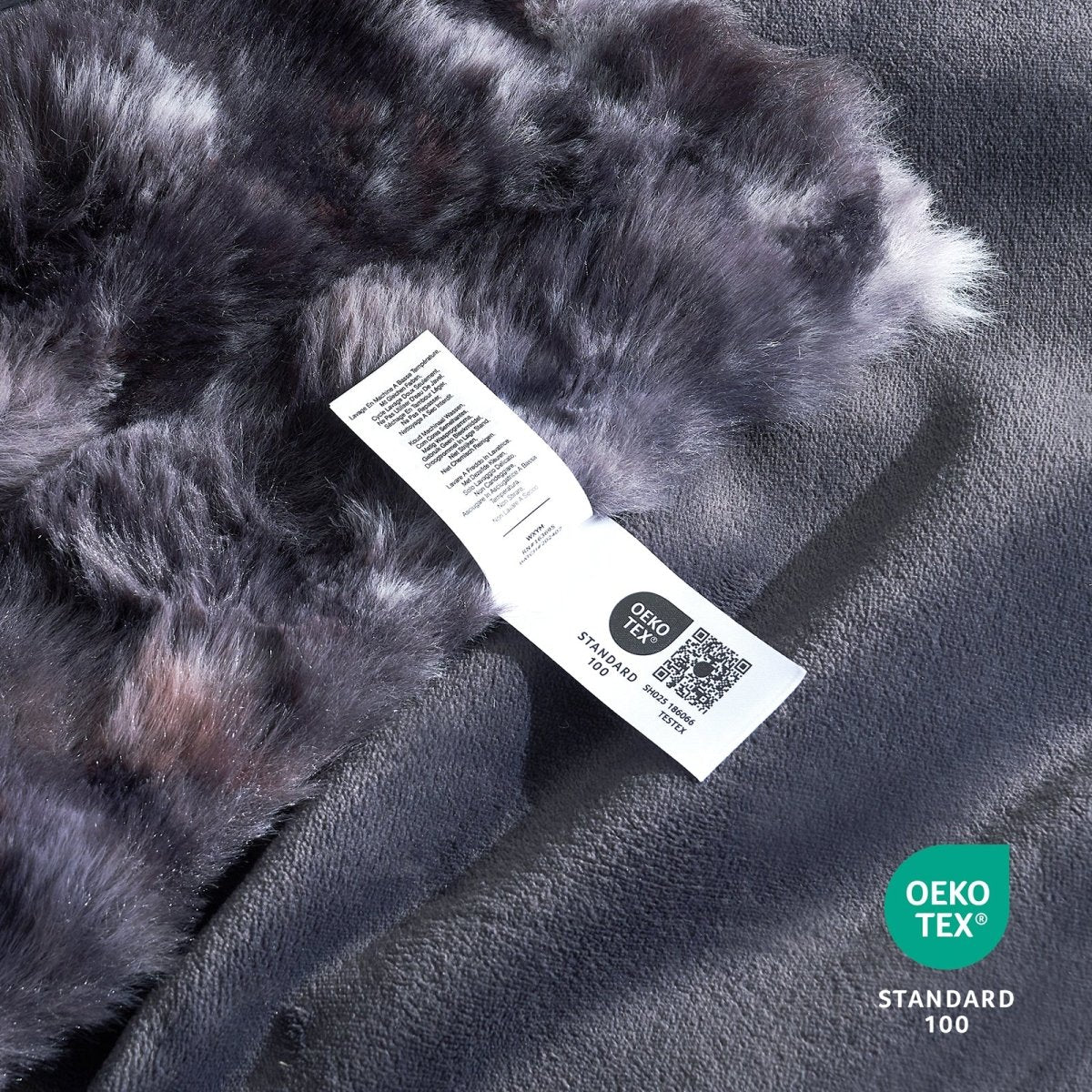 Close-up of OEKO-TEX certified faux fur tie-dye black blanket fabric. #Color_Tie-dye Black