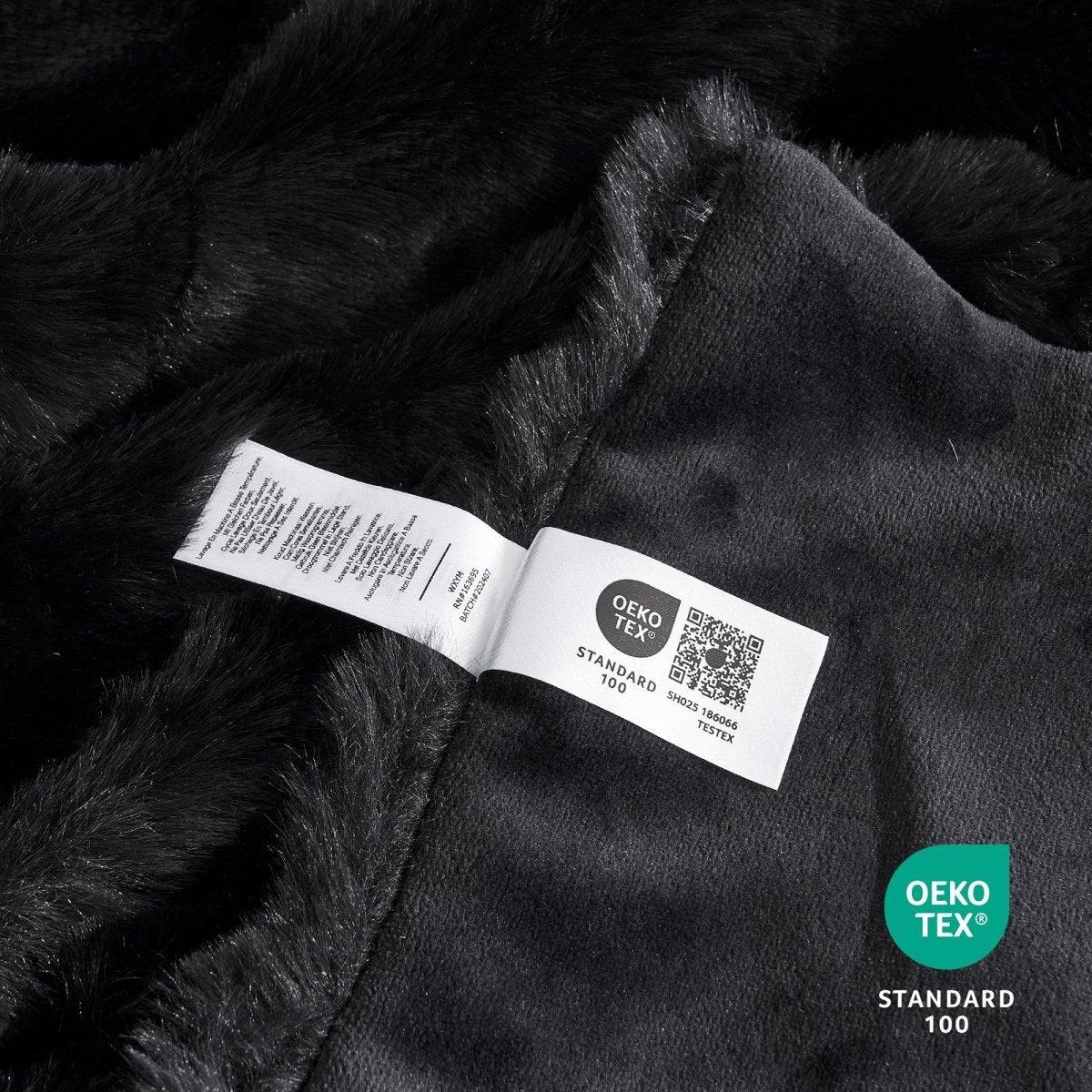 Close-up of OEKO-TEX certified faux fur black blanket fabric. #color_Black