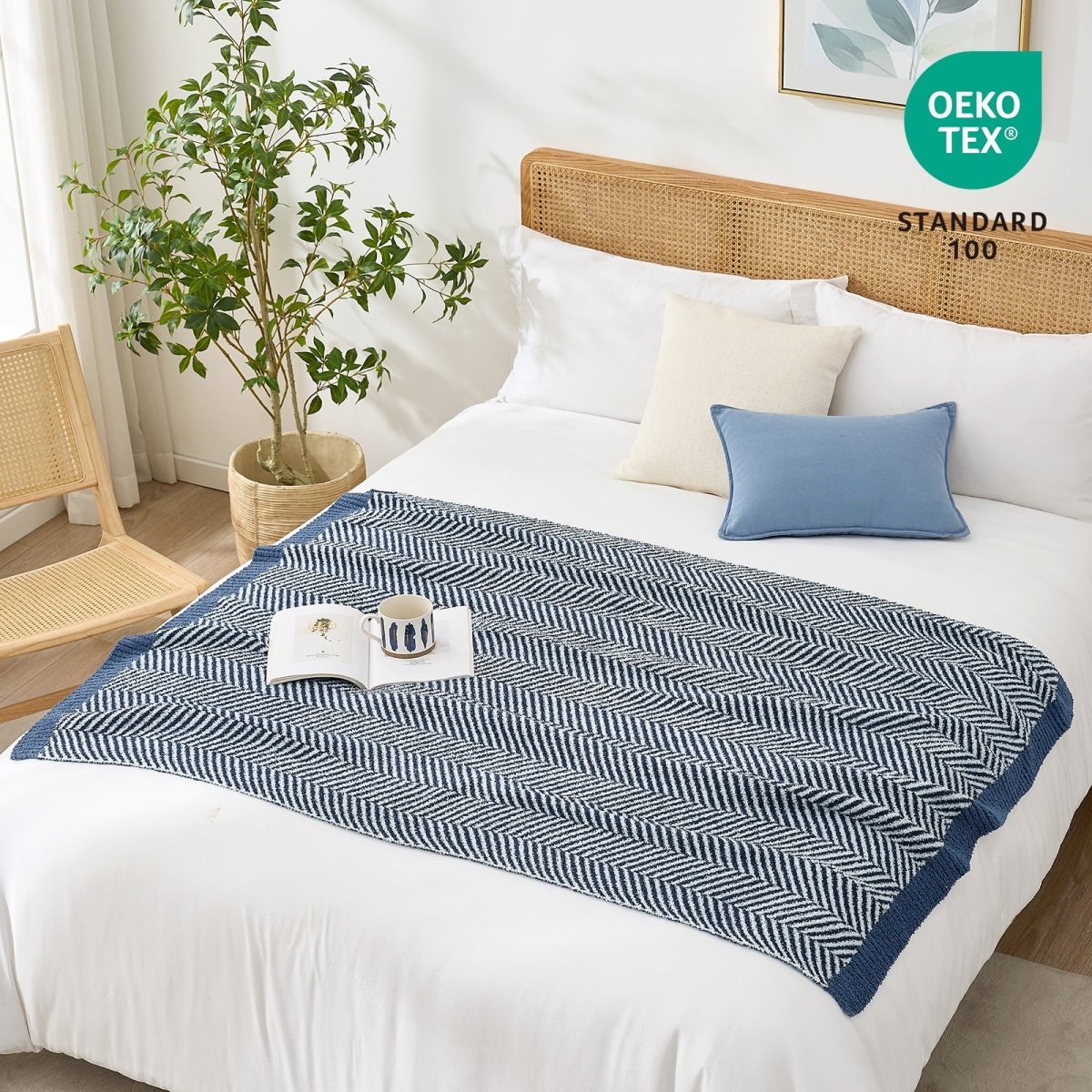 OEKO-TEX STANDARD 100 certified herringbone knit throw blanket styled on a white bed #color_Navy Blue