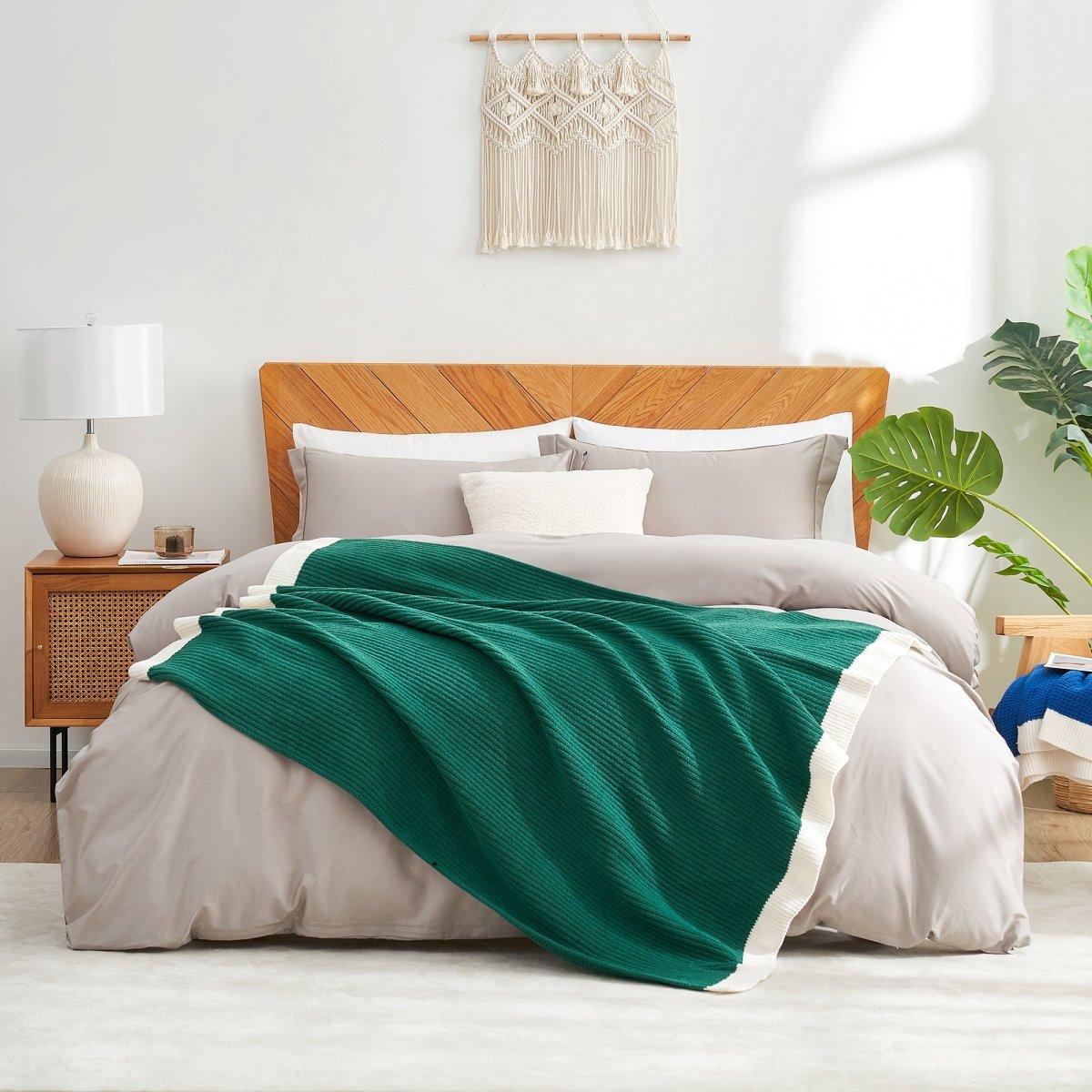 Chenille Waffle Knit Throw Blanket in Green styled on a bed, adding a fresh cozy touch. #color_Green