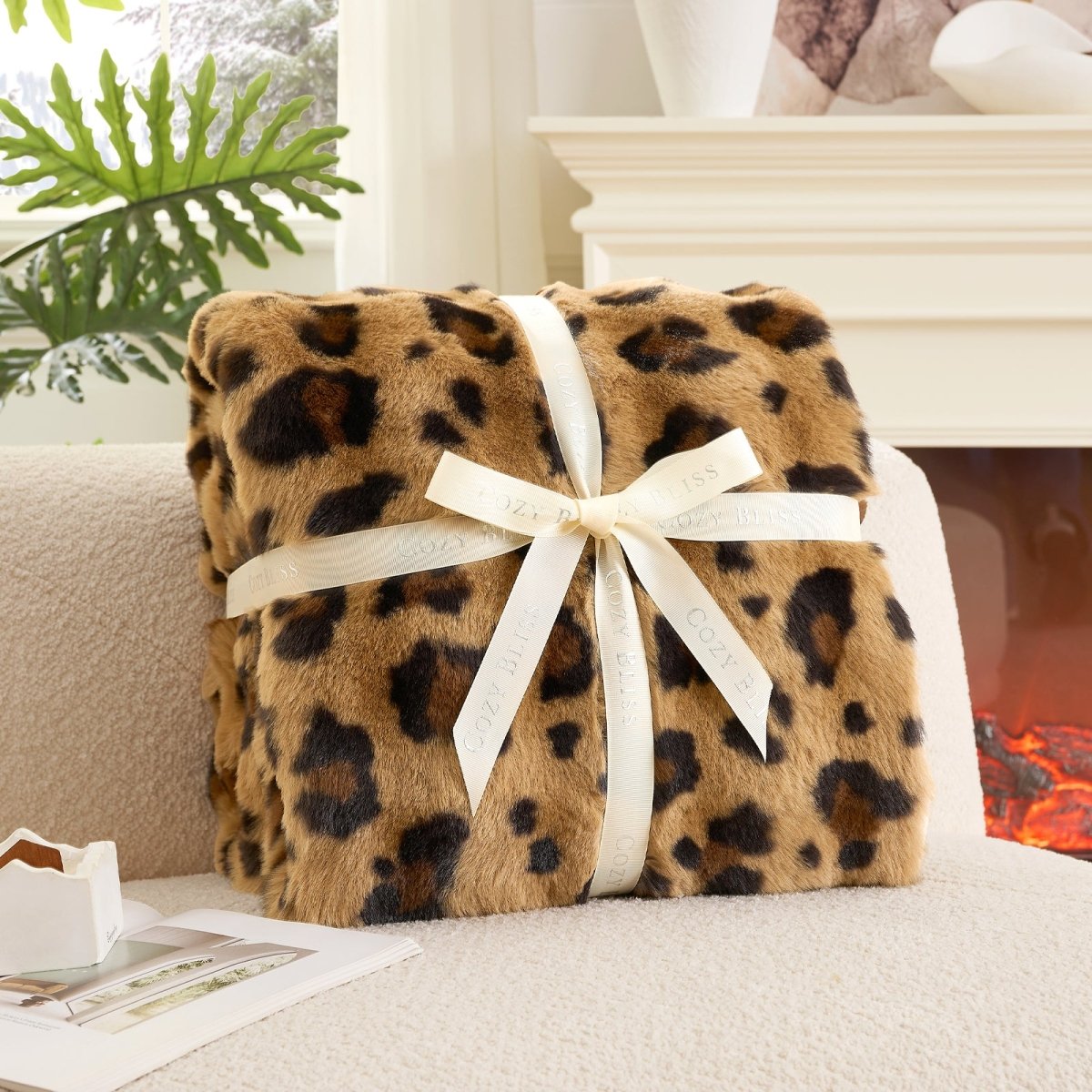Fluffy brown leopard blanket with a bow on a couch. #Color_ Brown Leopard