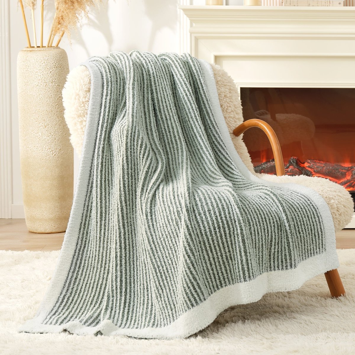 Soft Ribbed Feather Yarn Throw Blanket in Sage Green draped over an armchair, showcasing ribbed texture and soft feather yarn design. #color_Sage Green