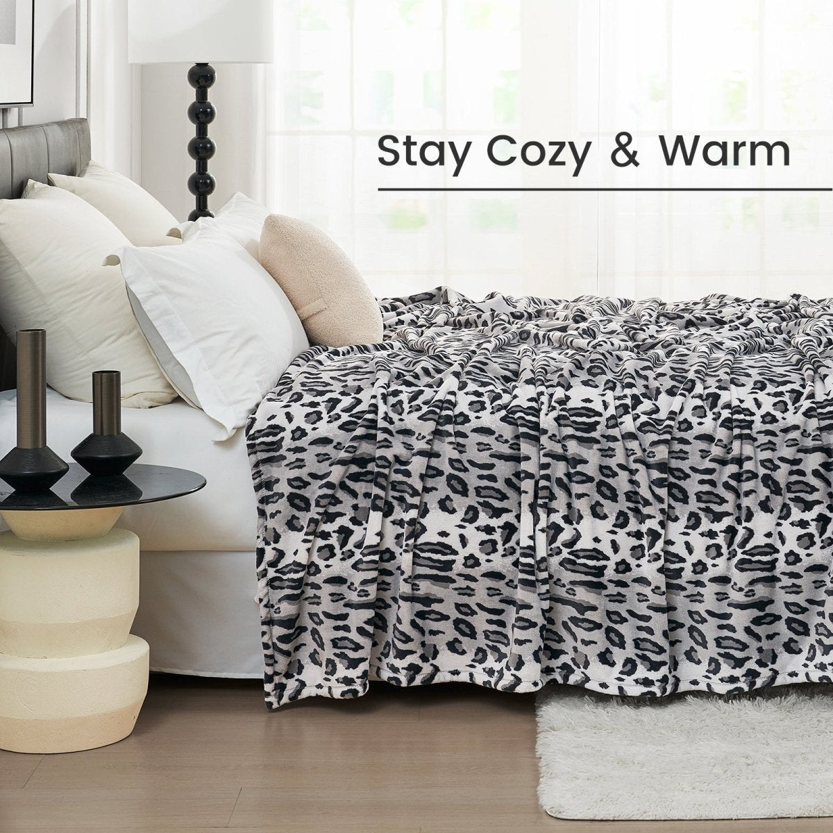 Cozy leopard print blanket on a bed, Stay Cozy & Warm text, ultra-soft cozy blanket, cooling comforter #color_Snow Leopard