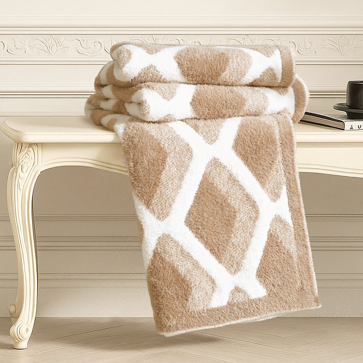 Diamond Feather Yarn Throw Blanket in Beige neatly folded on a table, showcasing plush texture and detailed diamond knit design. #color_Beige