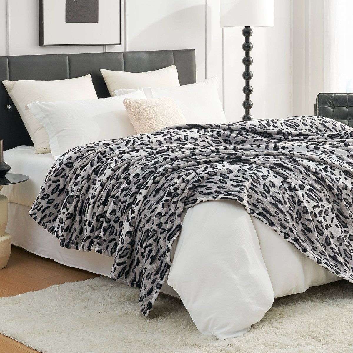 Leopard print blanket draped over a bed, cozy bedroom aesthetic. #color_Snow Leopard