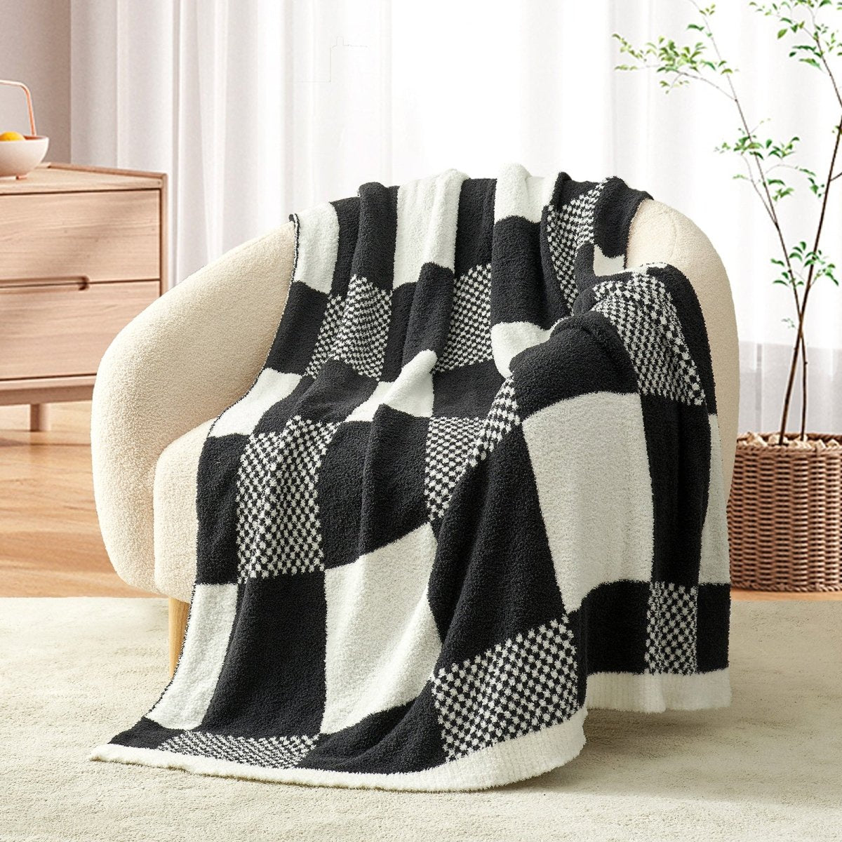 Checkered Feather Yarn Throw Blanket in Black & White front view draped over a chair, showcasing soft feather yarn texture and checkered pattern design. #color_Black & White