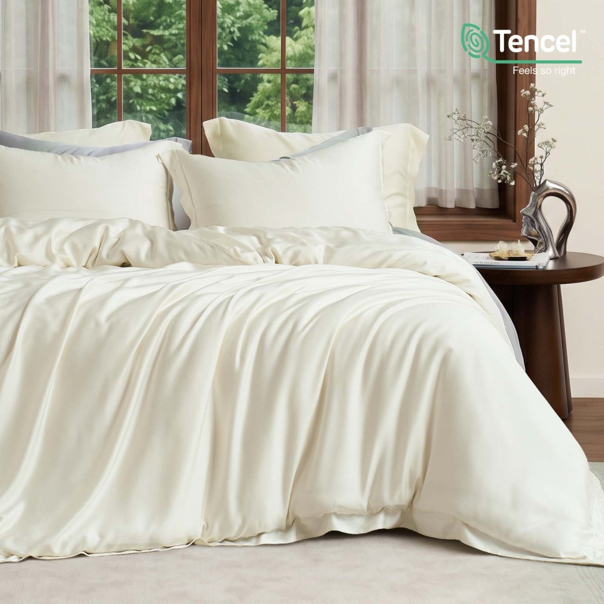 Cozy Bliss Tencel™ Eco-friendly Silky Duvet Cover Set displayed on a bed in a bedroom, showcasing the complete bedding set. #color_Cream White