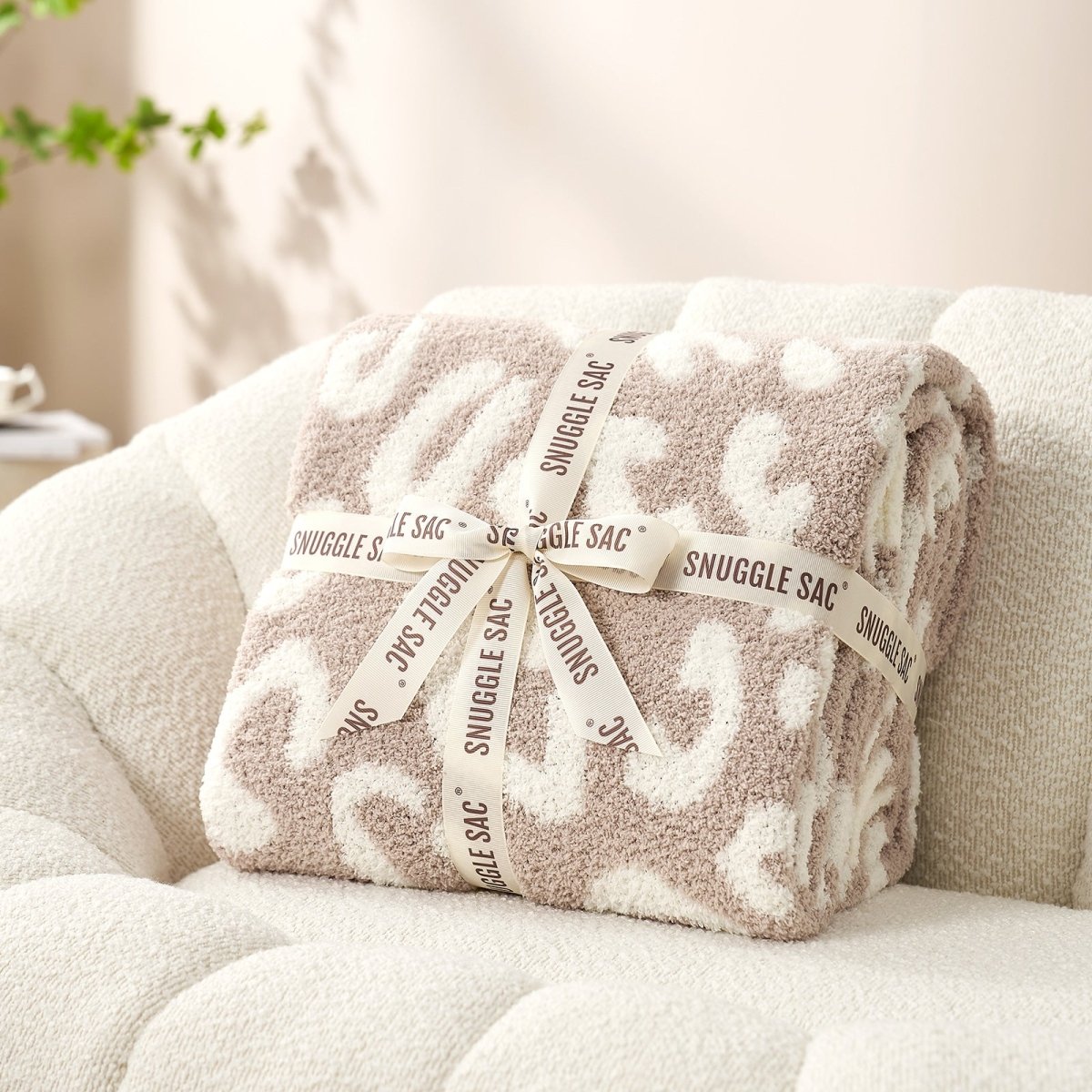 Reversible Leopard Feather Yarn Throw Blanket in Khaki Leopard neatly folded with ribbon, perfect as a cozy gift for holidays and special occasions. #color_Khaki Leopard