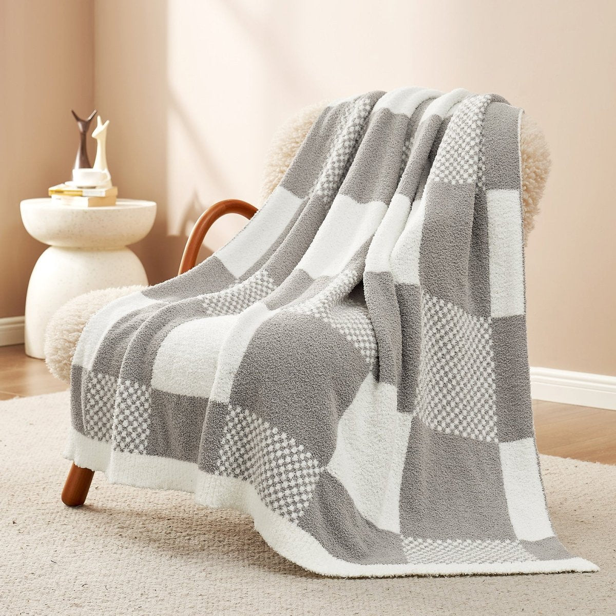Checkered Feather Yarn Throw Blanket in Grey front view draped over an armchair, showcasing soft feather yarn texture and checkered pattern design. #color_Grey