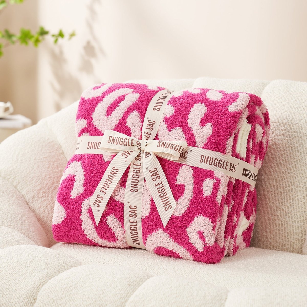 Reversible Leopard Feather Yarn Throw Blanket in Hot Pink neatly folded with ribbon, perfect for gifting and special occasions. #color_Hot Pink