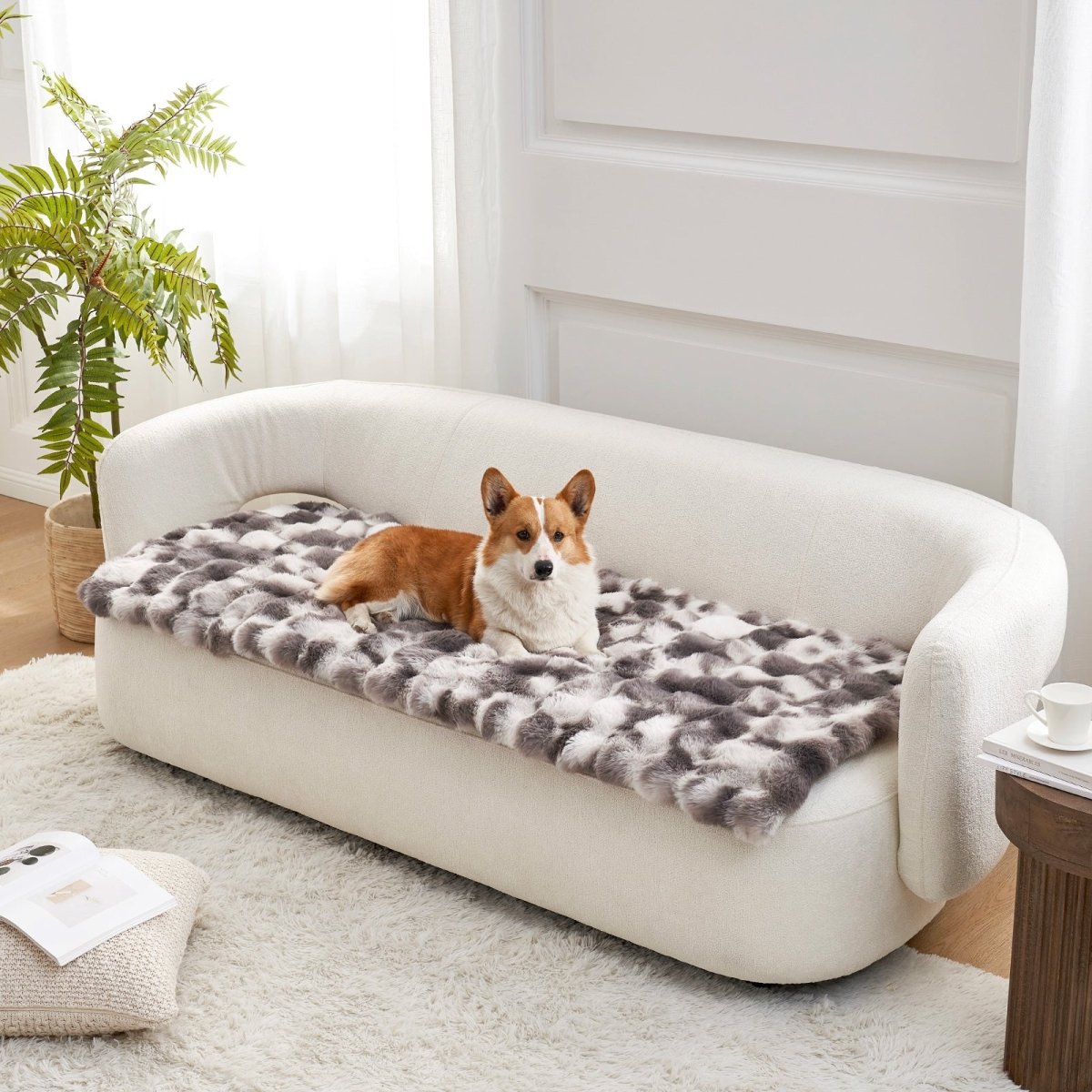 Dog lying on a tie-dye grey couch cover on a white couch in a bright room.#color_Tie-dye Grey