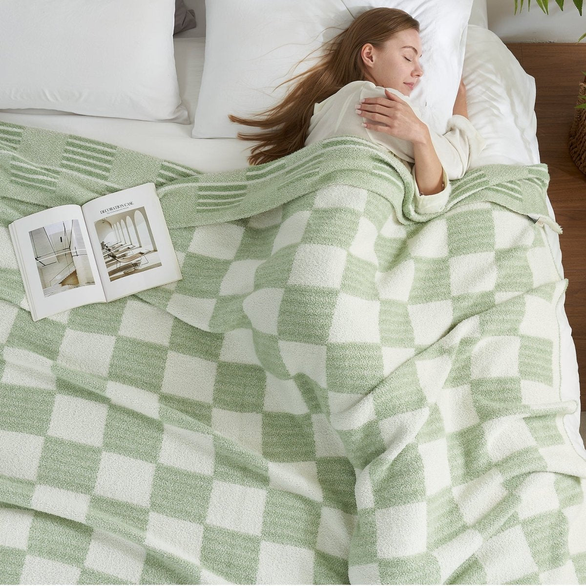 Woman sleeping comfortably under a Reversible Heather Checkered Feather Yarn Throw Blanket in Sage Green, perfect for everyday use. #color_Sage Green