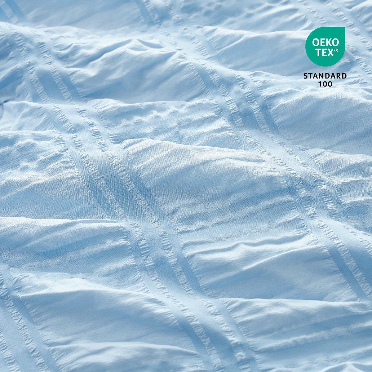 Close-up of Cozy Bliss Textured blue fabric with OEKO-TEX Standard 100 certification.#color_Sky Blue