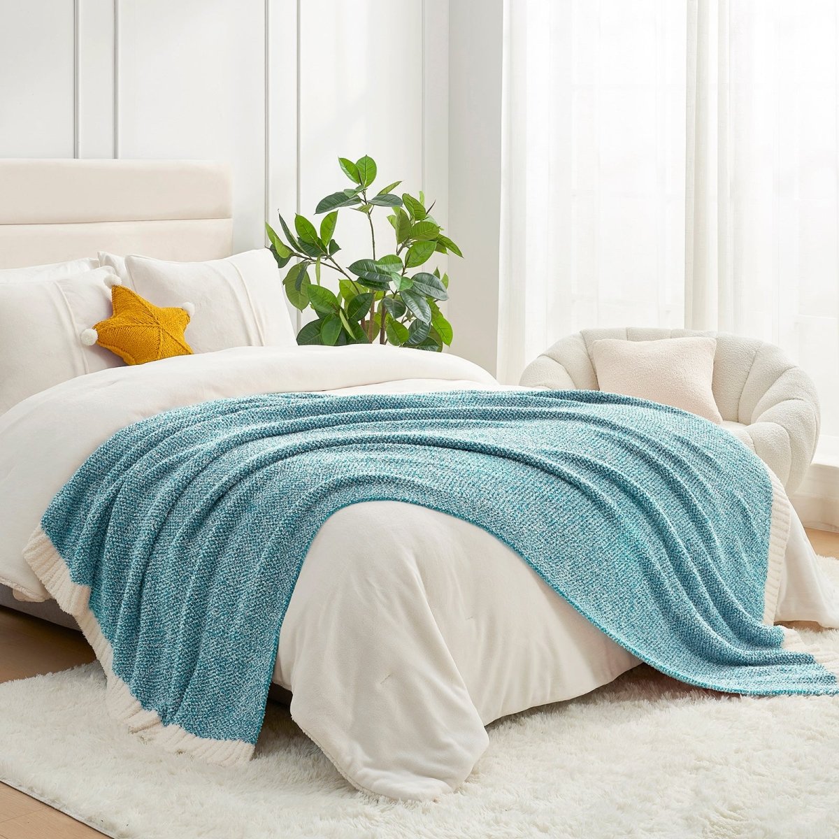 Heather Feather Yarn Throw Blanket in heather teal styled on a bed, enhancing bedroom decor with a soft, elegant and cozy layered look. #Color_Heather Teal