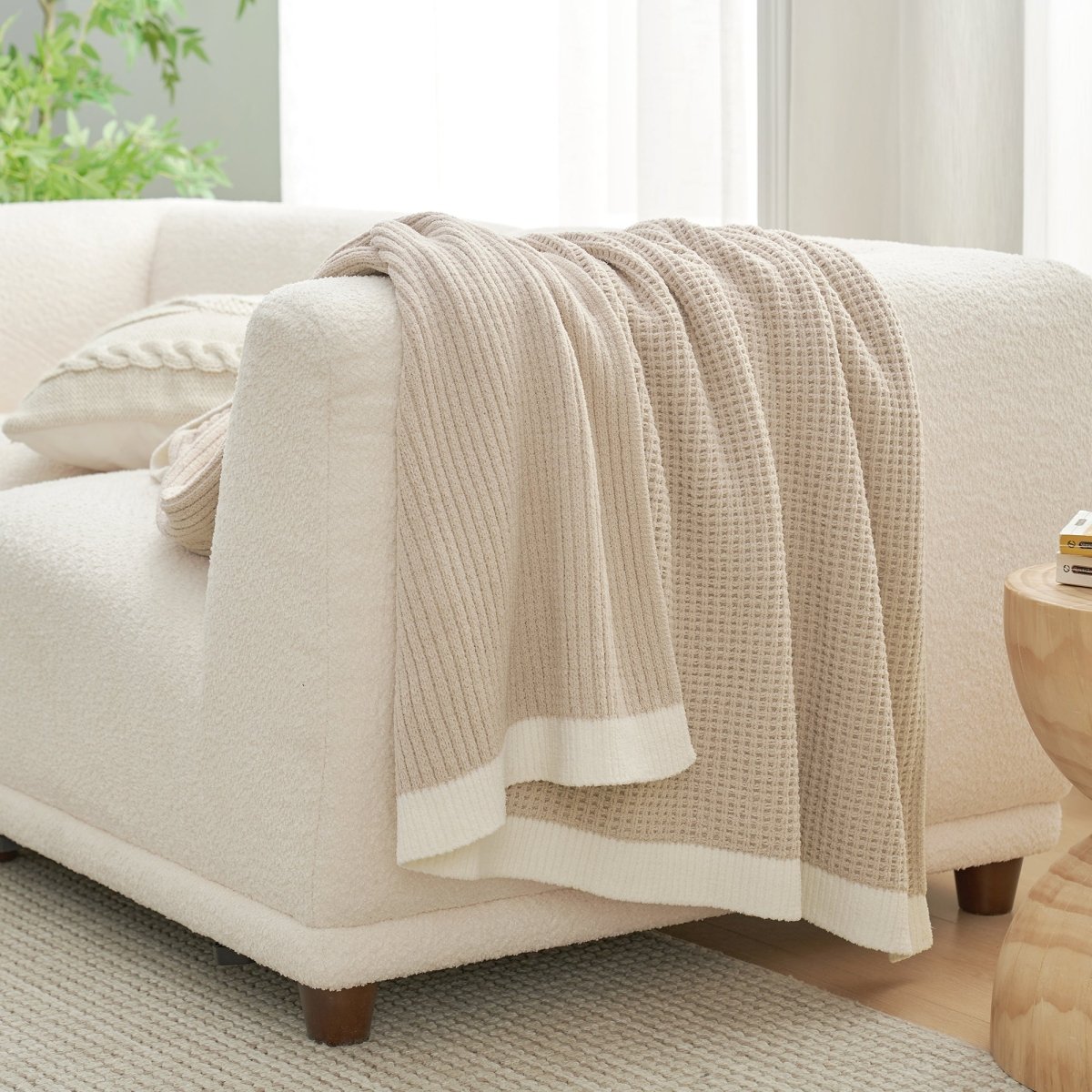 Chenille Waffle Knit Throw Blanket in Beige draped over a sofa, creating a cozy space. #color_Beige