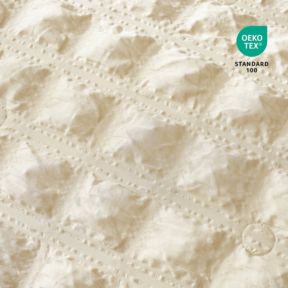 Close-up of Cozy Bliss Textured beige fabric with OEKO-TEX Standard 100 certification.#color_Beige