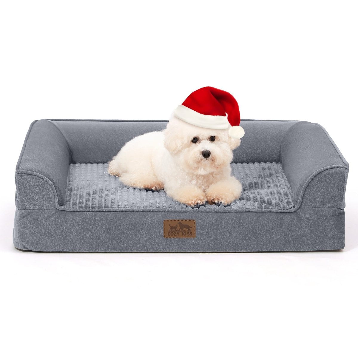 Small white dog wearing a red Santa hat sitting on a gray pet bed#Color_Grey