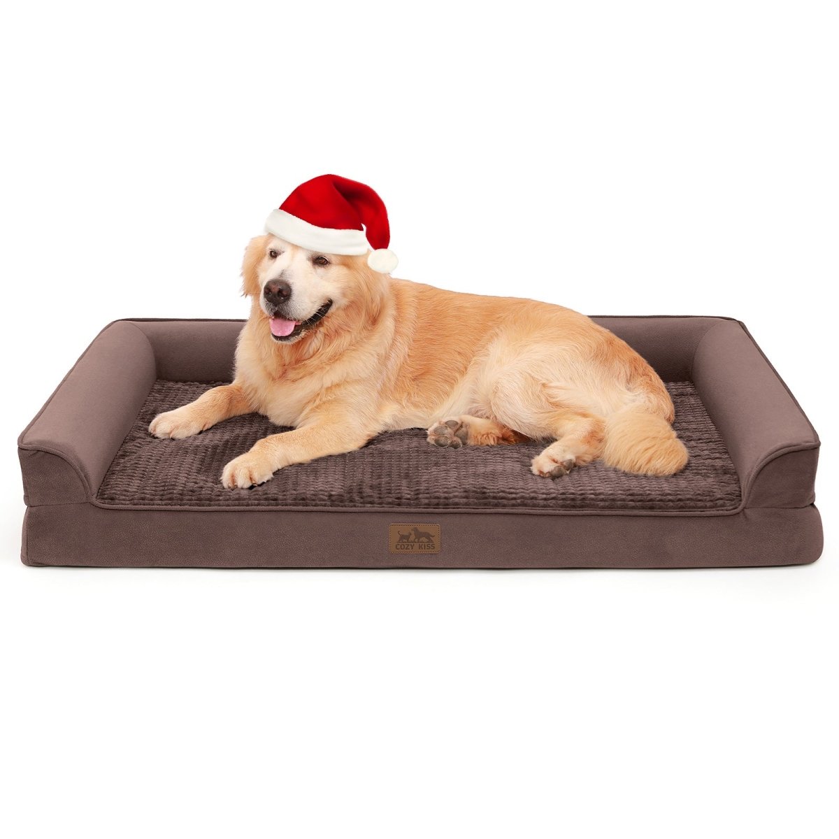 Dog lying on a brown pet bed wearing a Santa hat on a white background#Color_Brown