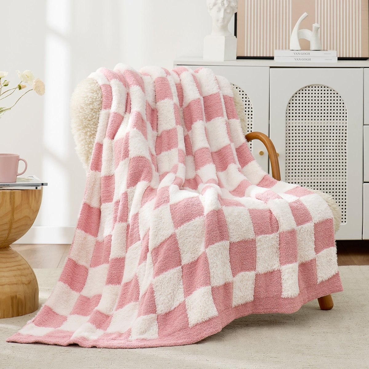 Checkered Faux Fur Feather Yarn Throw Blanket in Pink White draped over an armchair, adding a soft and cozy vibe. #Color_Pink white