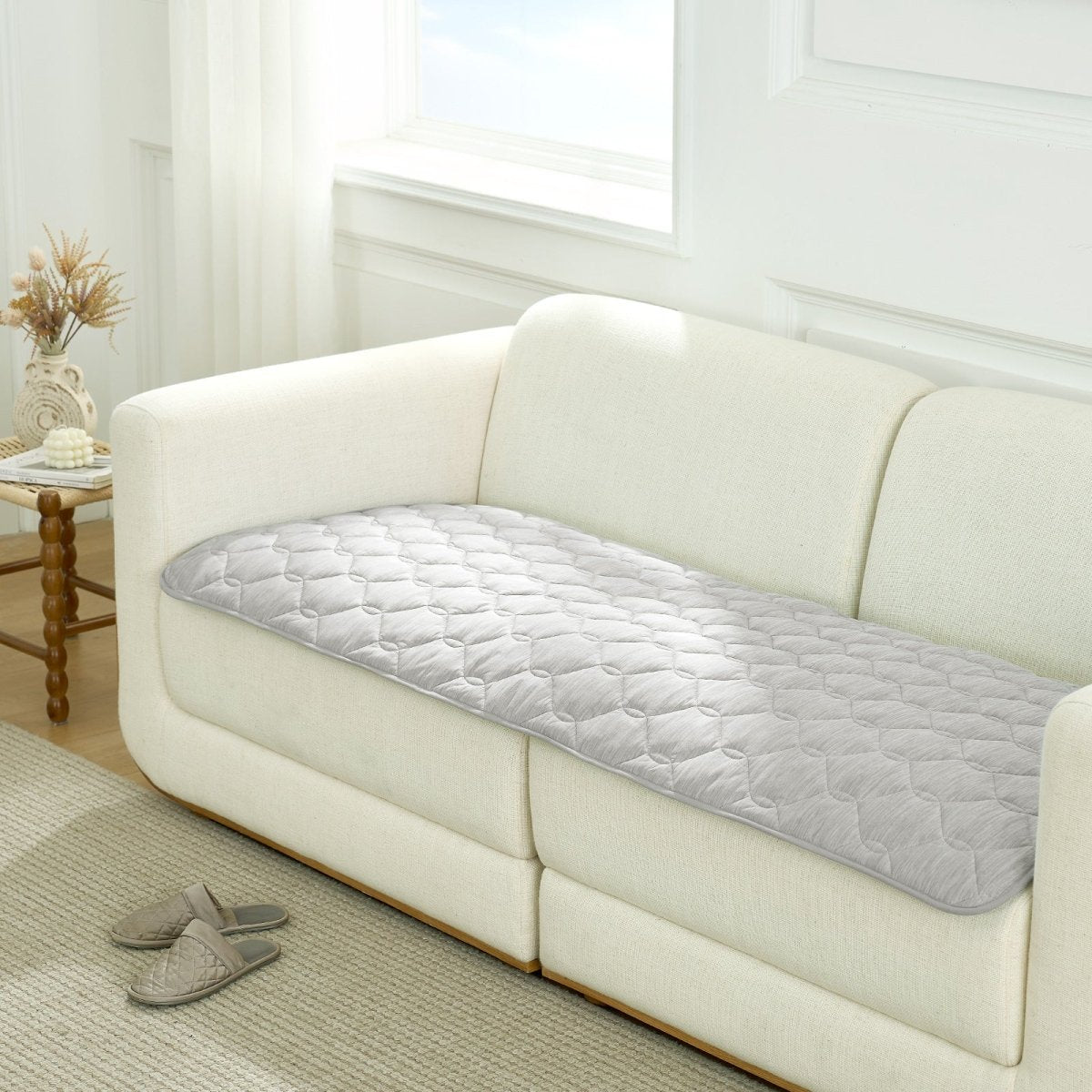 Gray couch cover on a white sofa in a living room setting.#color_Grey