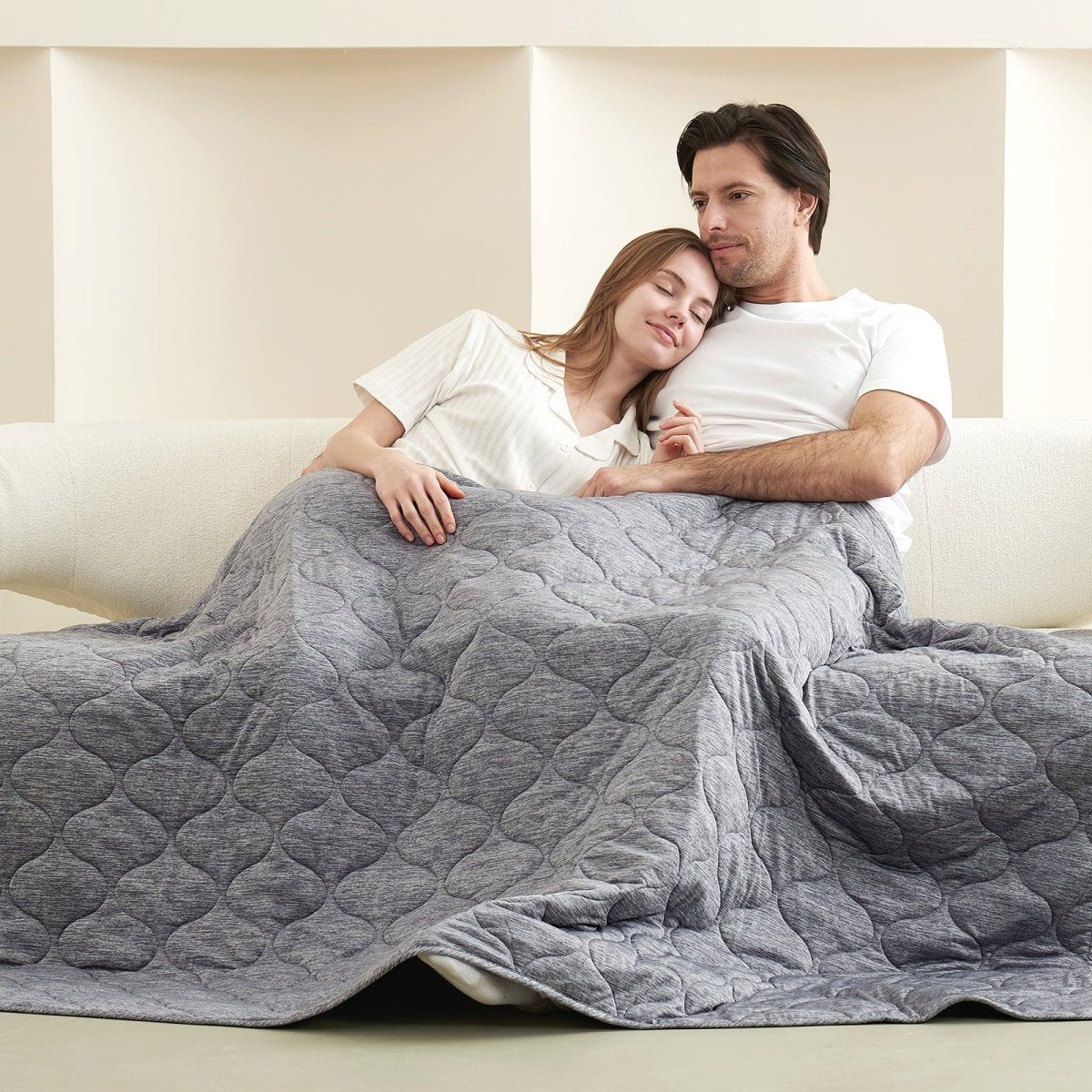 Cozy couple relaxing under gray cooling blanket, perfect for enhanced sleep and relaxation #color_Charcoal Grey