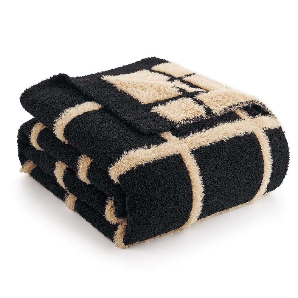 Folded black and beige patterned blanket on a white background #color_Black