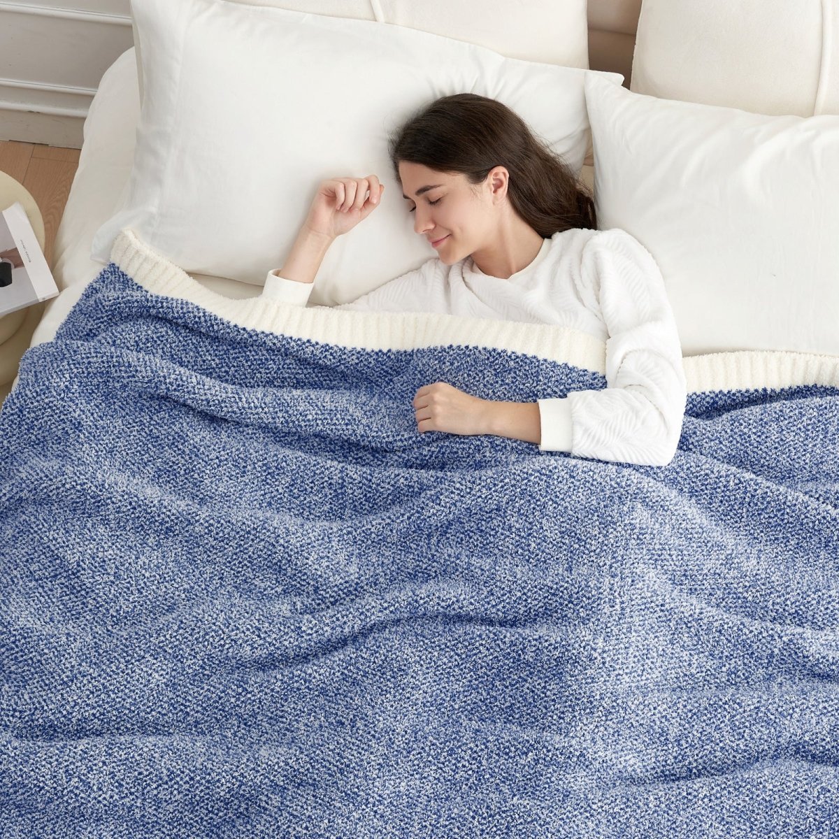 Woman sleeping under a Heather Feather Yarn Throw Blanket in Dark Blue, offering warmth. #color_Dark Blue