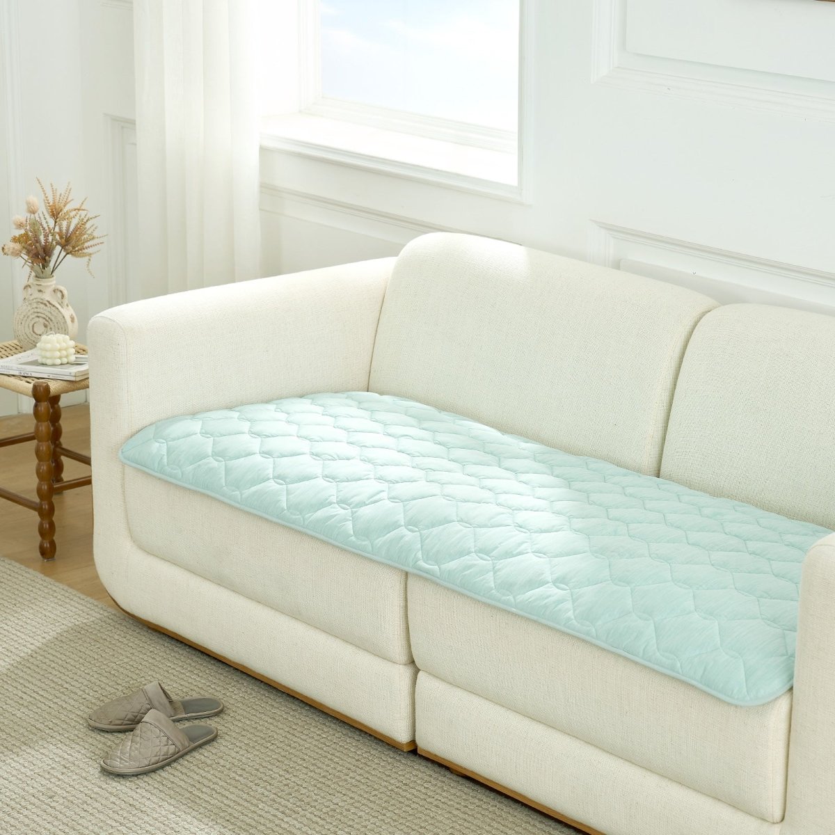 Green couch cover on a white sofa in a living room setting.#Color_Light Mint Green