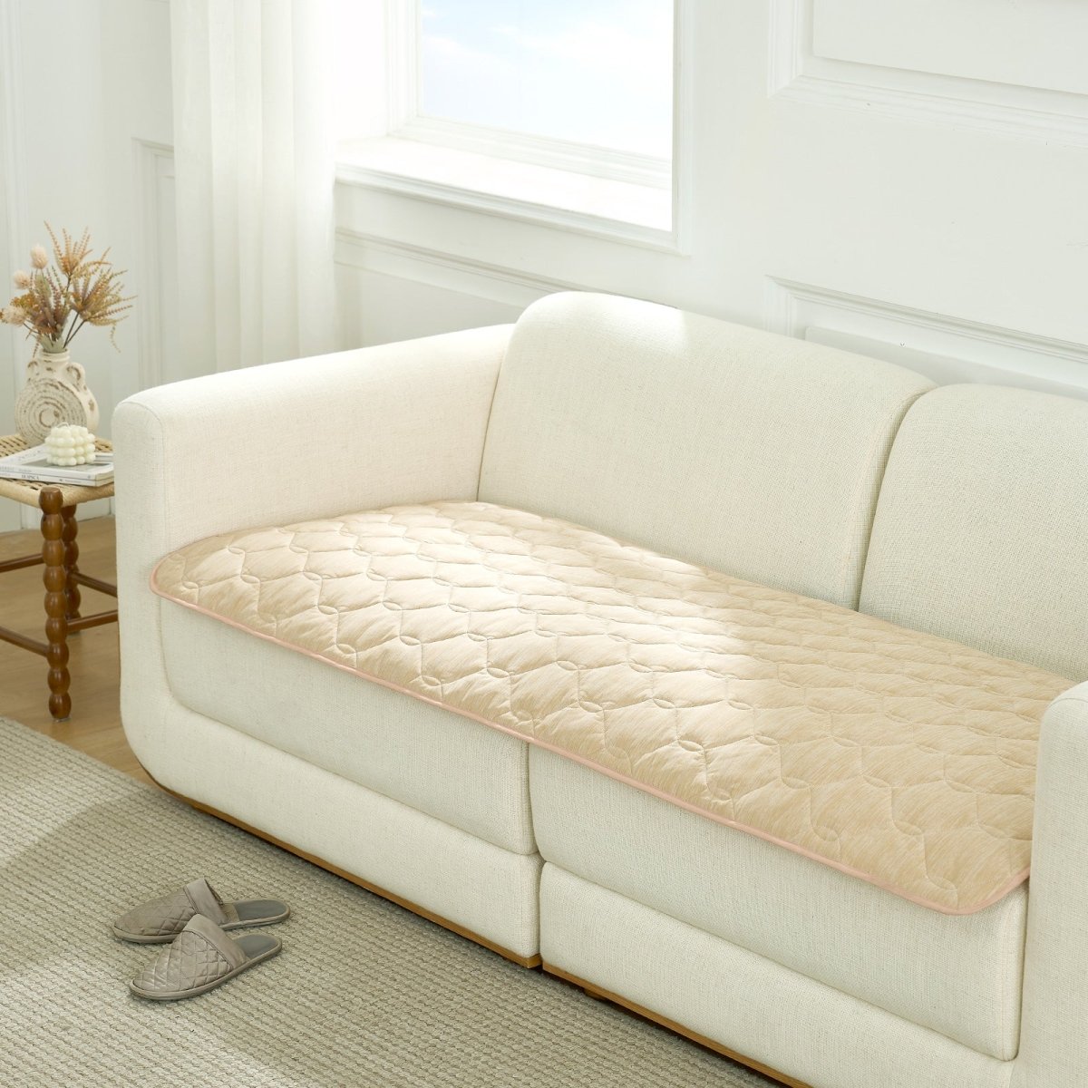 Beige couch cover on a white sofa in a living room setting.#Color_Beige