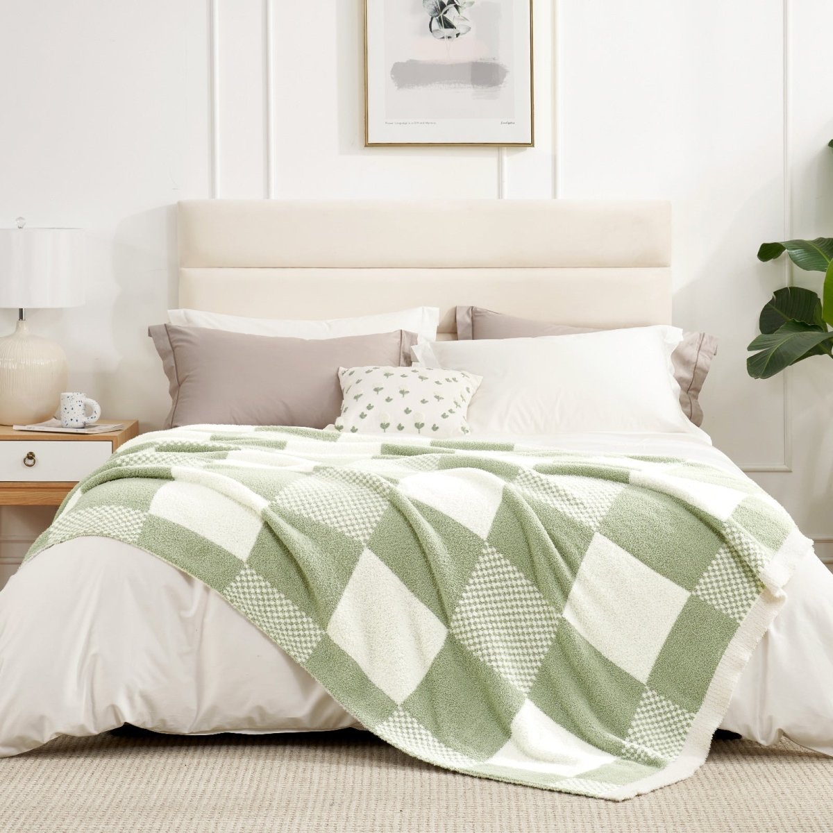 Checkered Feather Yarn Throw Blanket in Sage Green & White styled on a bed, adding a calm and cozy look. #color_Sage Green & White