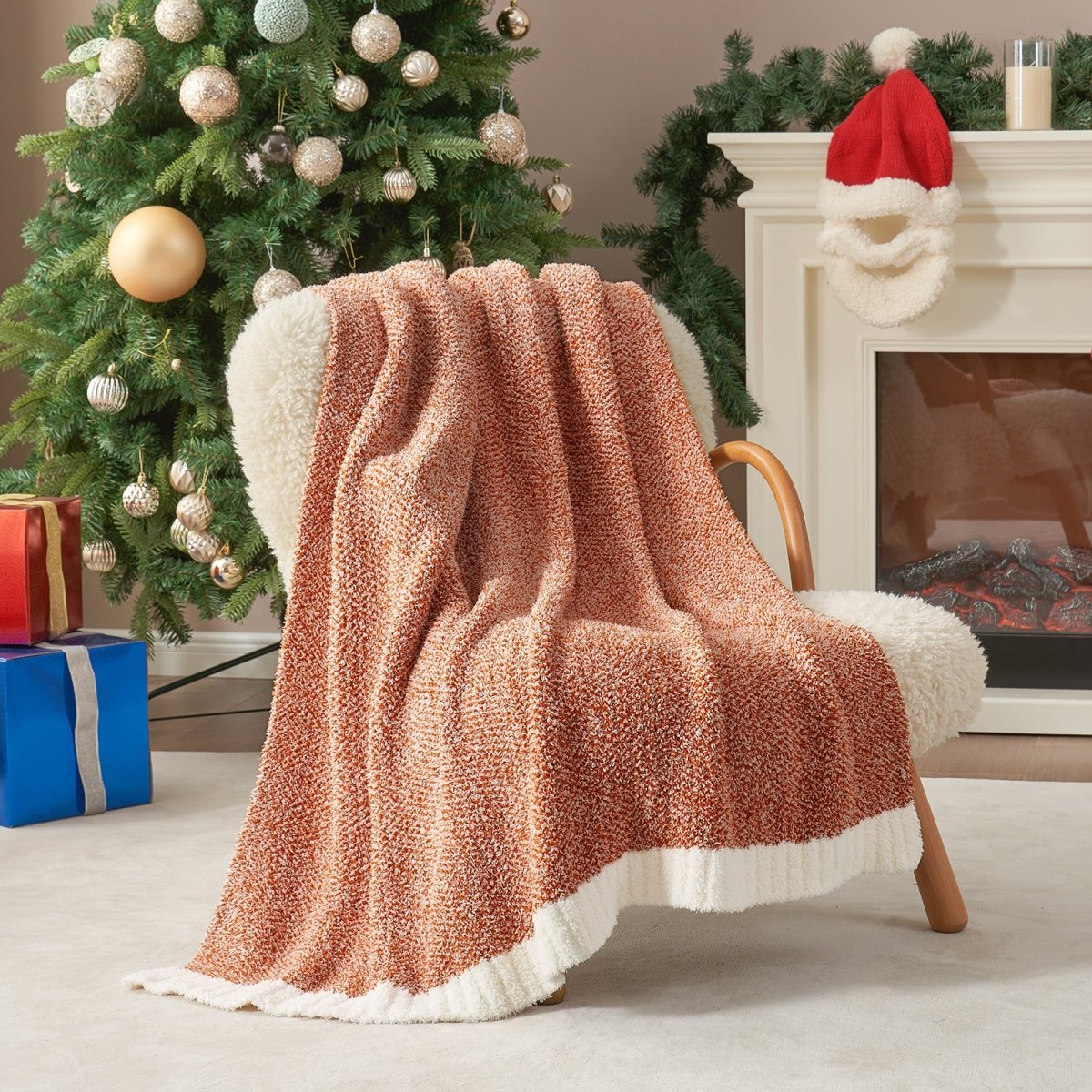 Heather Feather Yarn Throw Blanket in Orange draped over an armchair, creating a warm atmosphere. #color_Orange