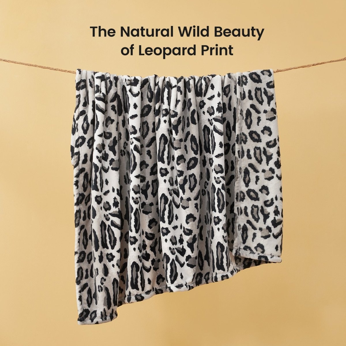 Leopard print milkyplush throw blanket in Snow Leopard displayed hanging, highlighting natural animal print pattern #color_Snow Leopard