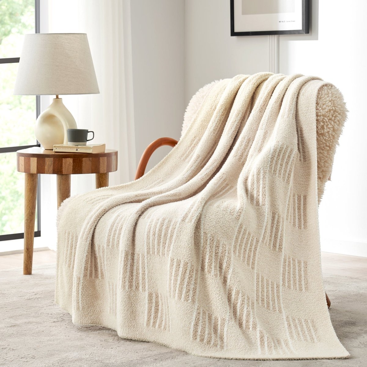 Reversible Heather Checkered Feather Yarn Throw Blanket in Cream White draped over an armchair, highlighting its soft feel and elegant checkered pattern. #color_Cream White