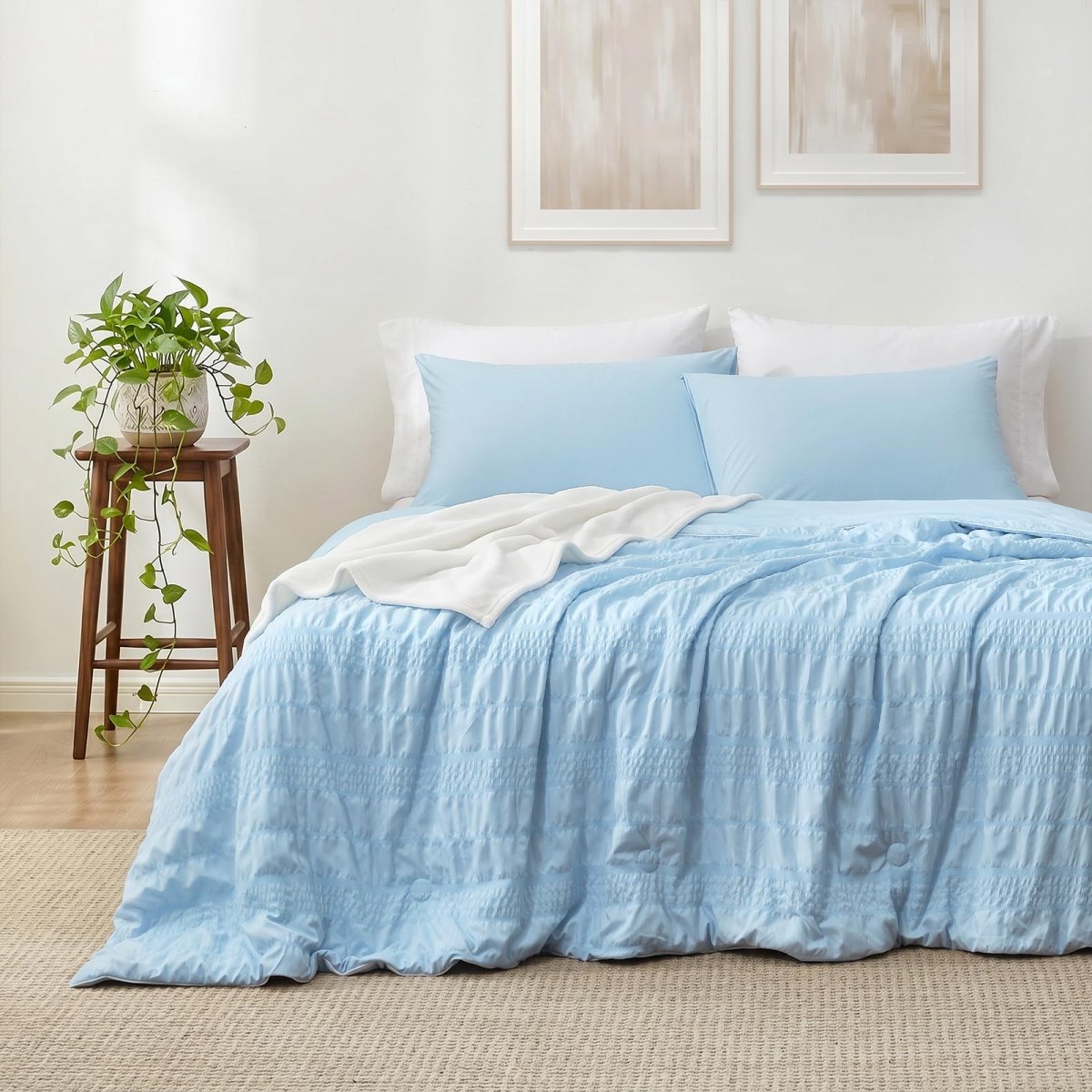 Cozy Bliss seersucker cooling comforter on a bed in front view.#color_Sky Blue