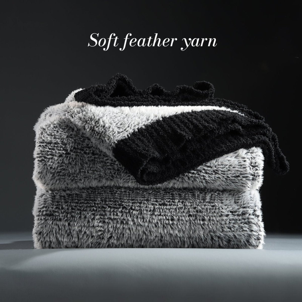 Faux Mink Feather Knit Throw Blanket in Black neatly folded stack, showcasing soft feather yarn and premium texture. #color_Black