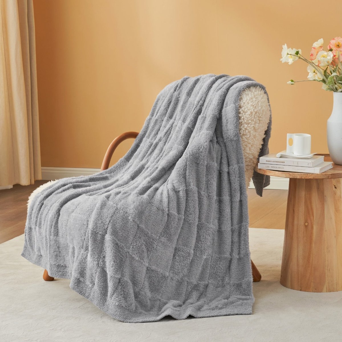 Checkered Faux Fur Feather Yarn Throw Blanket in Light Grey draped over an armchair, adding a modern cozy feel. #Color_Light Grey