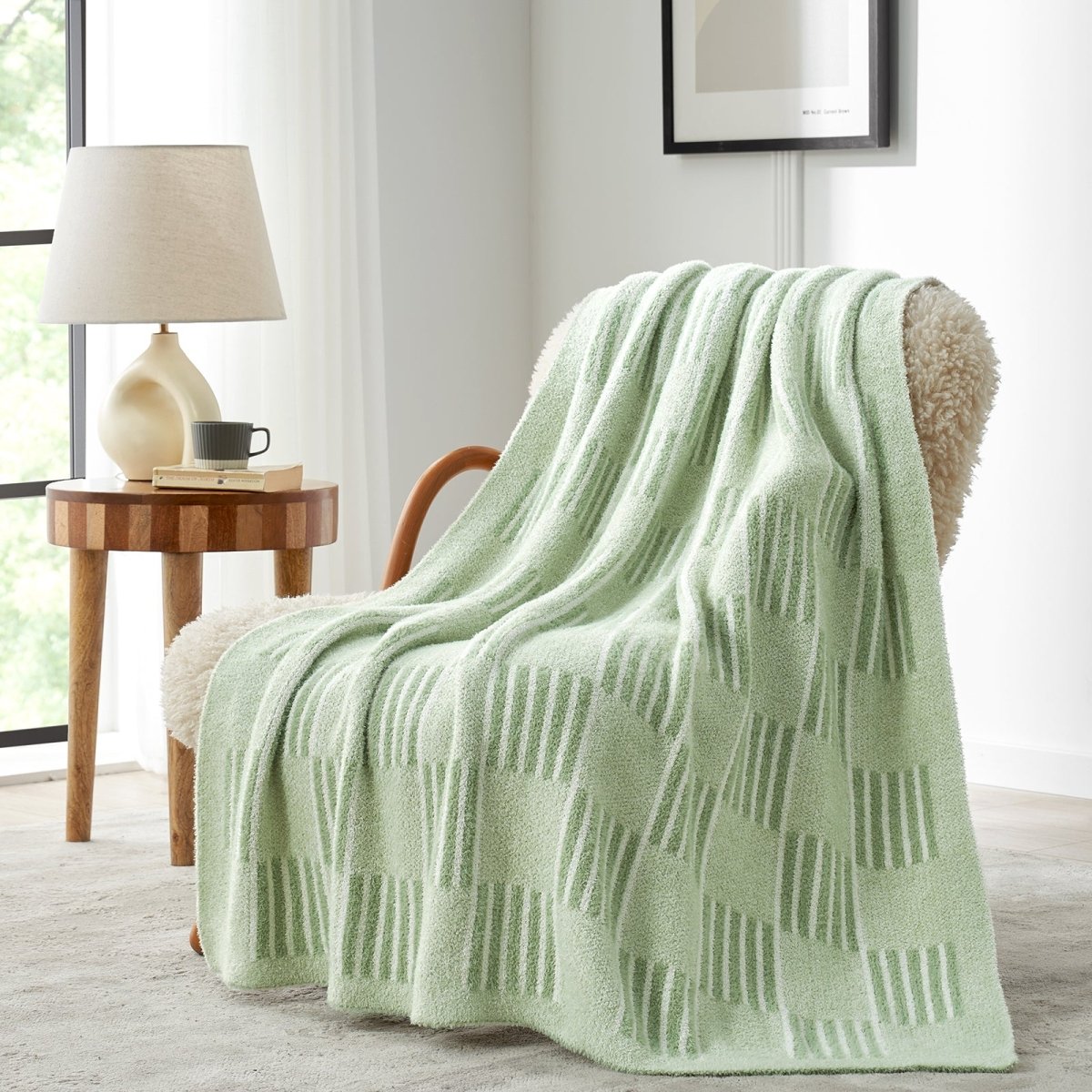 Reversible Heather Checkered Feather Yarn Throw Blanket in Sage Green draped over an armchair, adding a fresh and cozy touch to your space. #color_Sage Green