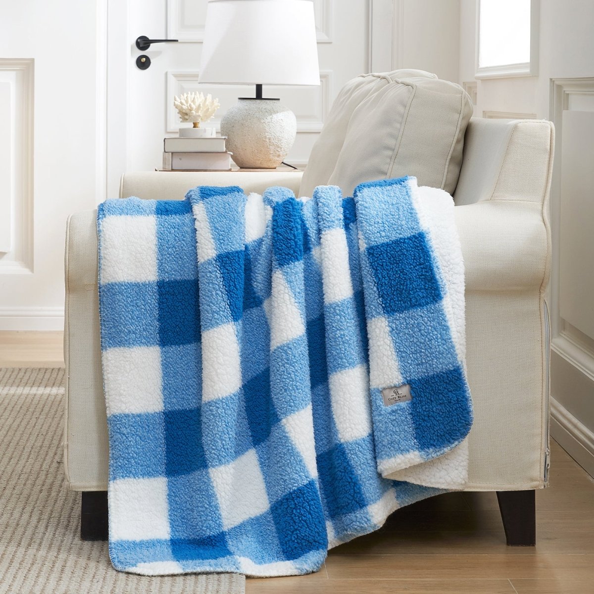 Buffalo sherpa throw blanket in Buffalo Plaid-light blue draped over a sofa, creating a warm and cozy bedroom look #color_Buffalo Plaid-light blue