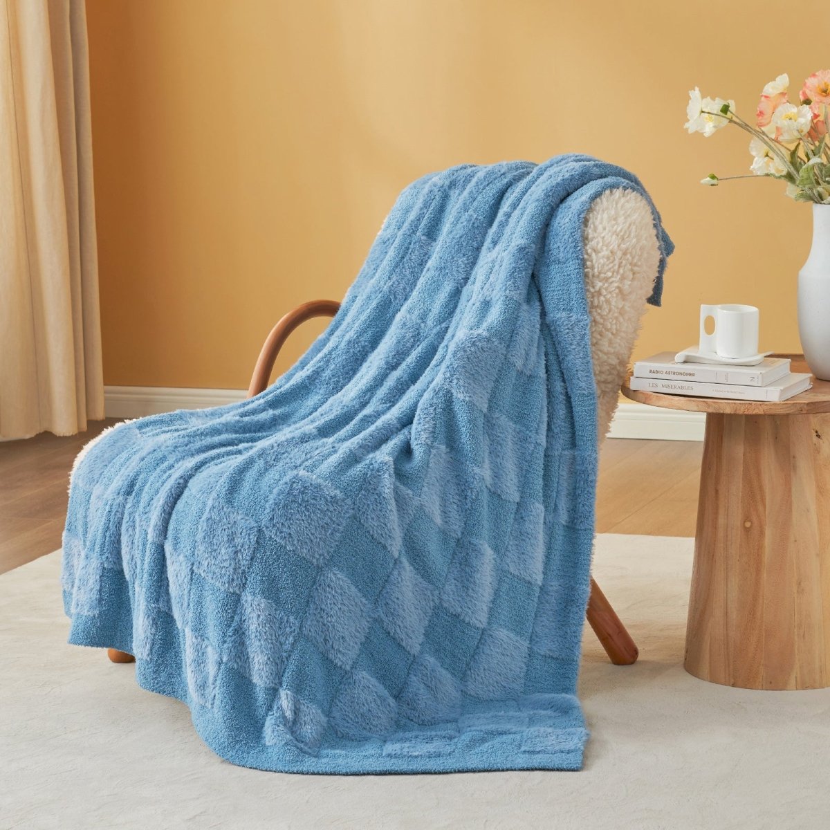 Checkered Faux Fur Feather Yarn Throw Blanket in Blue draped over an armchair, adding a cool and cozy touch. #color_Blue