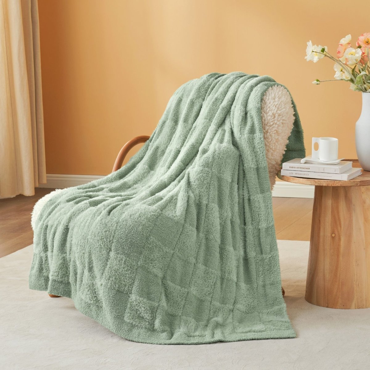 Checkered Faux Fur Feather Yarn Throw Blanket in Sage Green draped over an armchair, adding a calm and cozy feel. #color_Sage Green